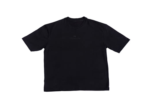 An oversized dark-colored short-sleeve oversized T-shirt with a small logo or text near the chest area, displayed against a plain background.