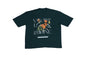 An oversized dark teal short-sleeve T-shirt featuring a bold "VOGUE" text design with floral elements and a small hanging object, displayed against a plain background.